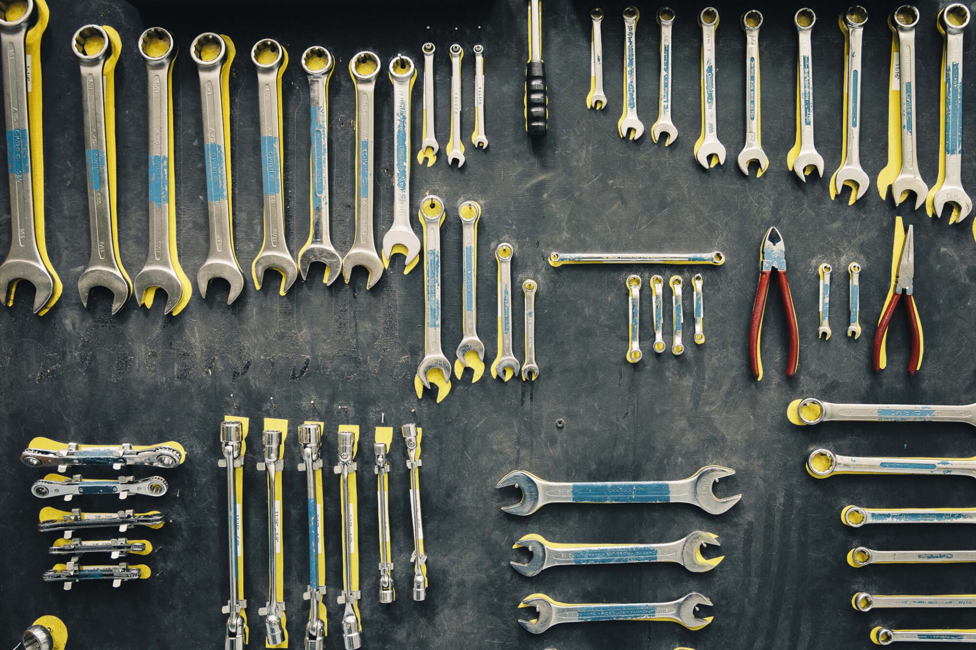 Wrenches and pliers hang up on a wall - tools for engineering courses in Bristol